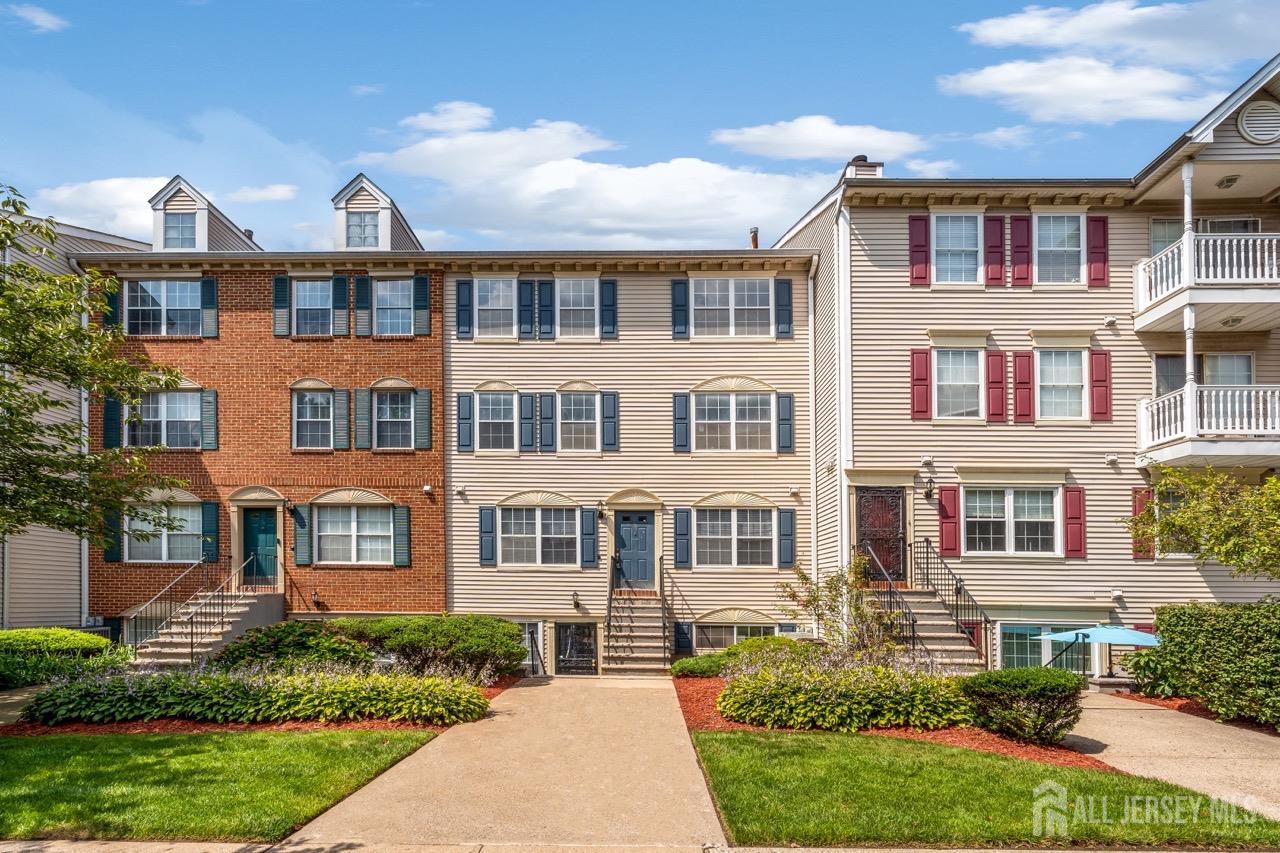 a front view of a residential apartment building with a yard