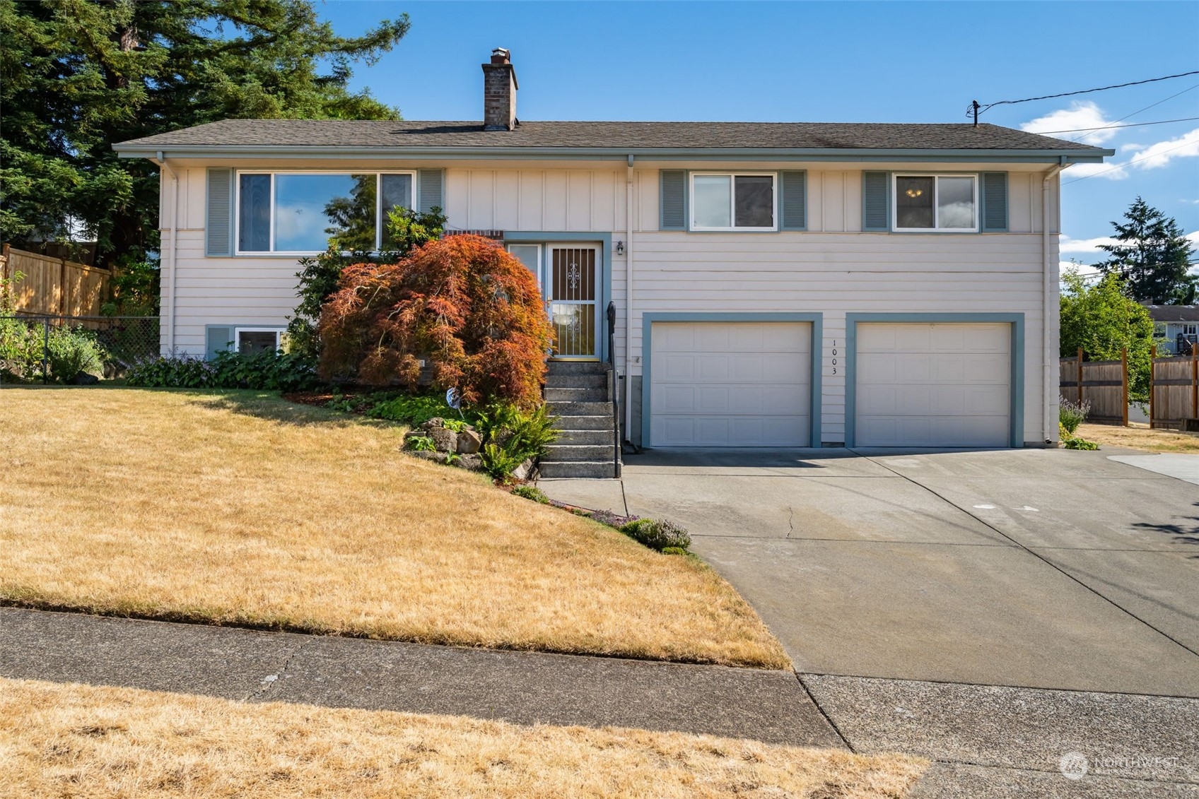 a front view of a house with a yard and garage