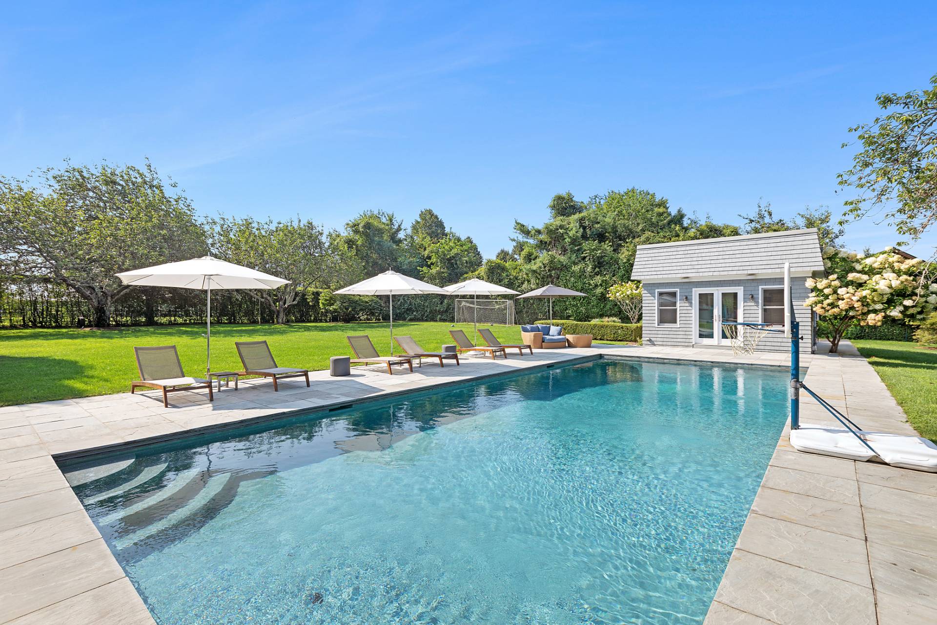 a view of swimming pool with outdoor seating and yard