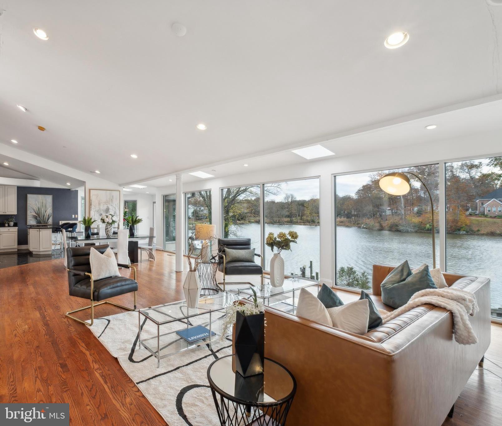 a living room with furniture floor to ceiling windows and a floor to ceiling window