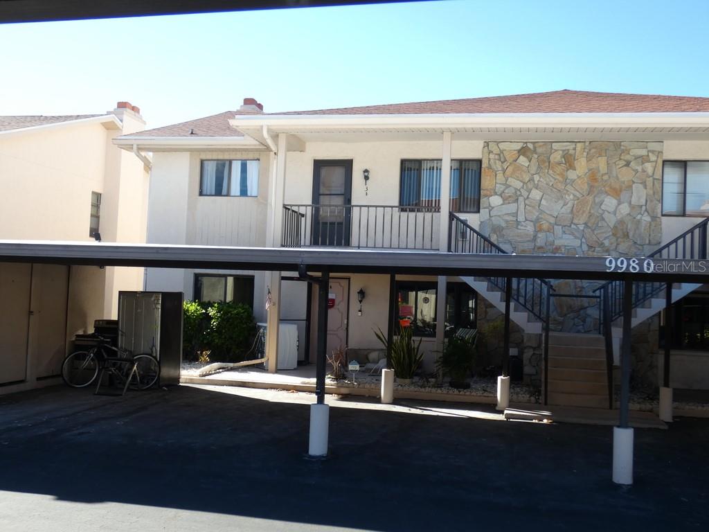 a front view of a house with glass windows and table