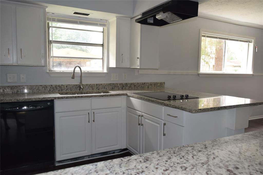 a kitchen with granite countertop a sink and a window