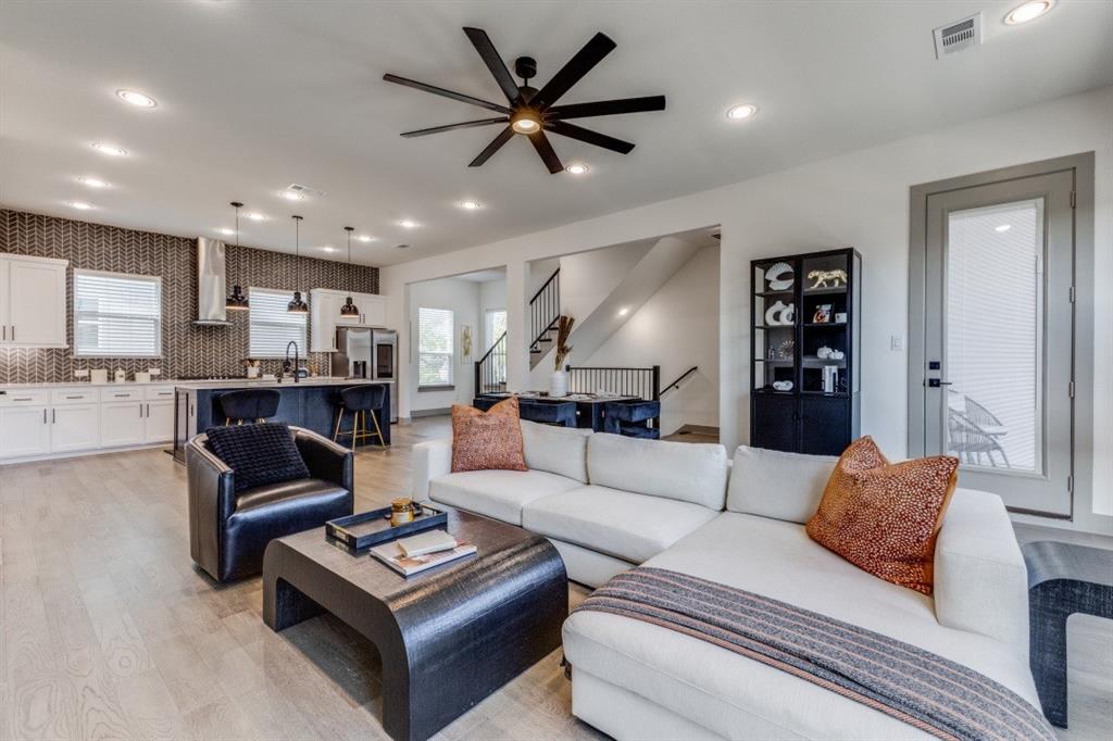 a living room with furniture and view of kitchen