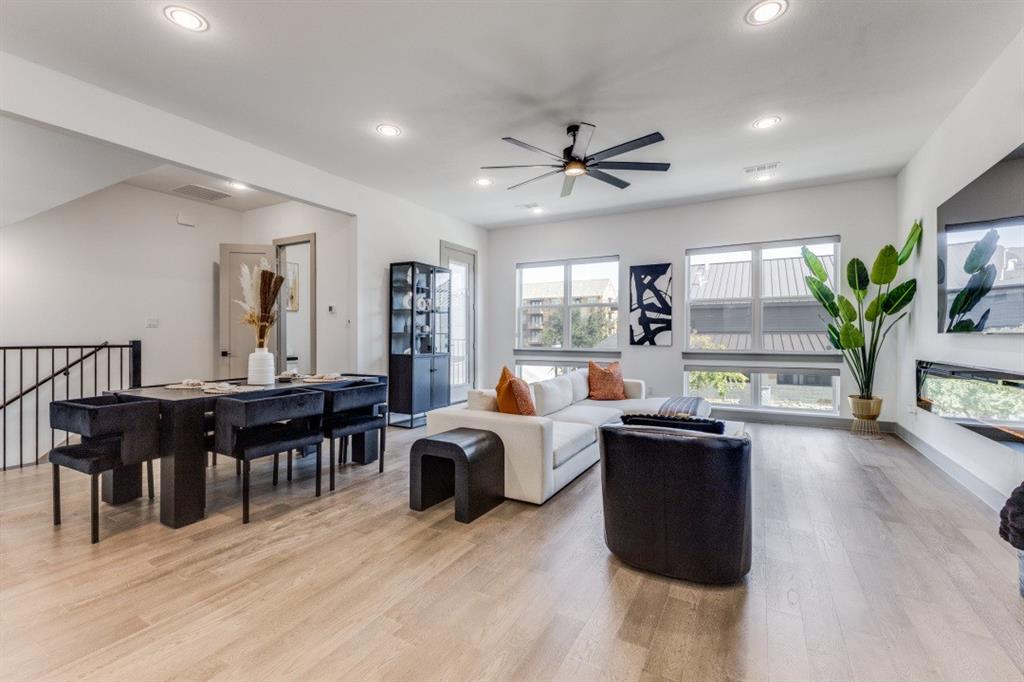 a living room with furniture a window and wooden floor