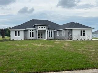 a front view of house with yard and green space