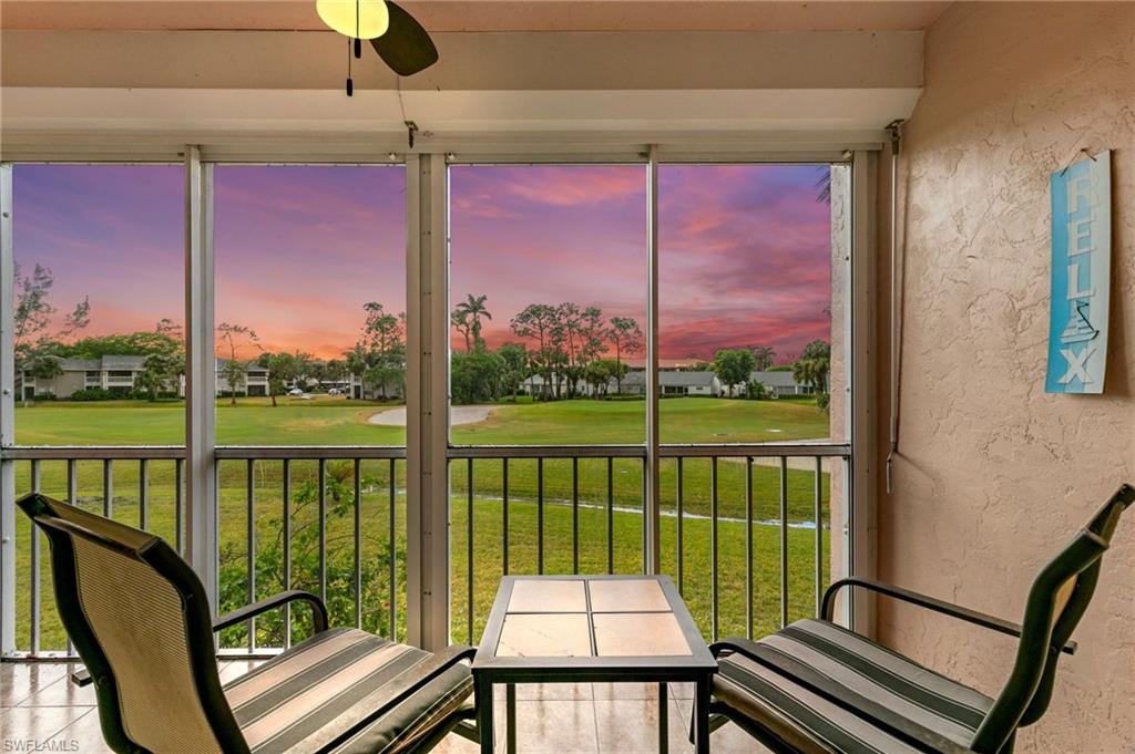 a view of a balcony with floor to ceiling windows with wooden floor