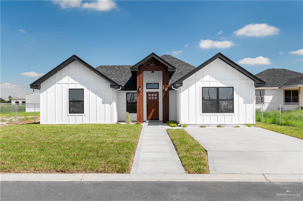 Modern farmhouse style home featuring a front lawn