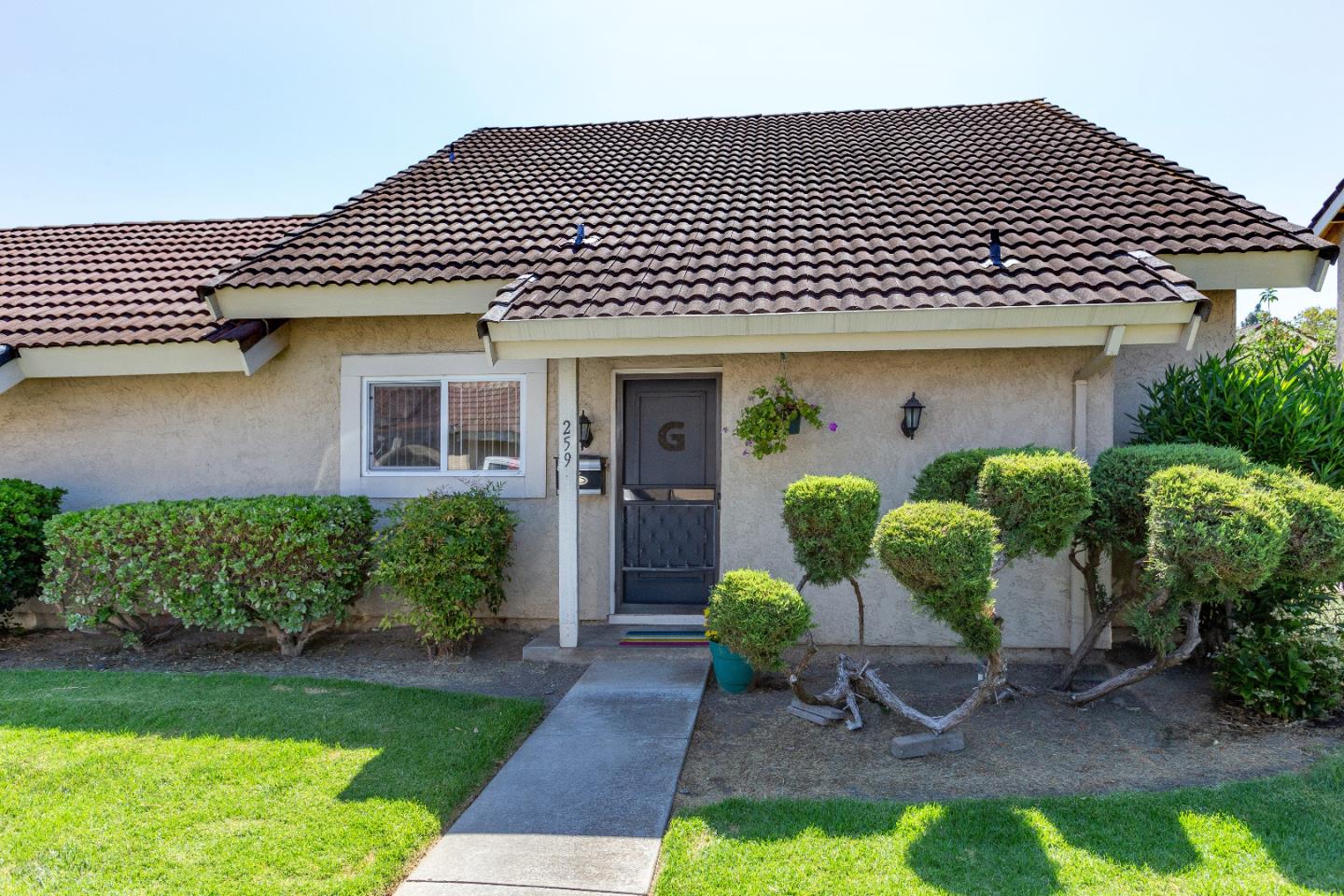 a front view of a house with garden