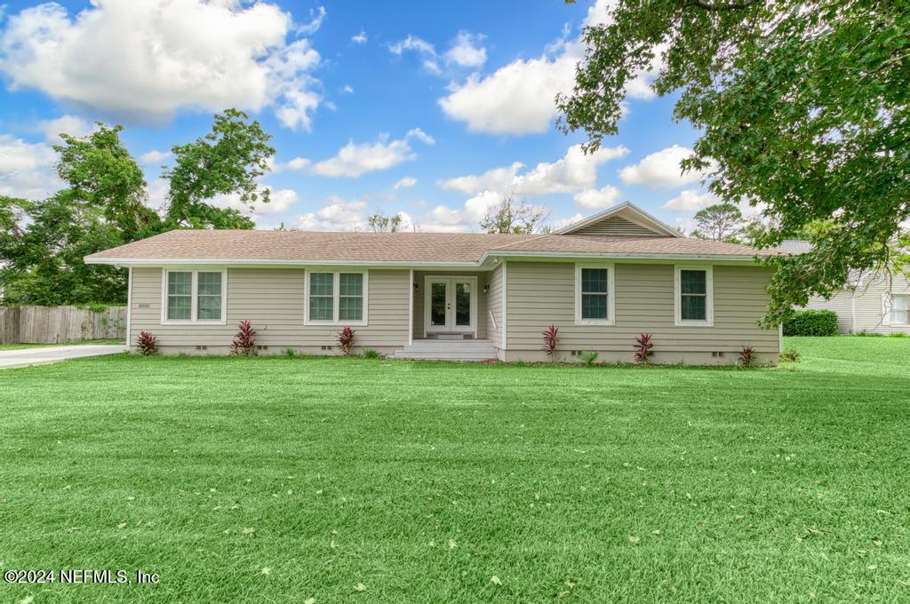 a front view of a house with a garden