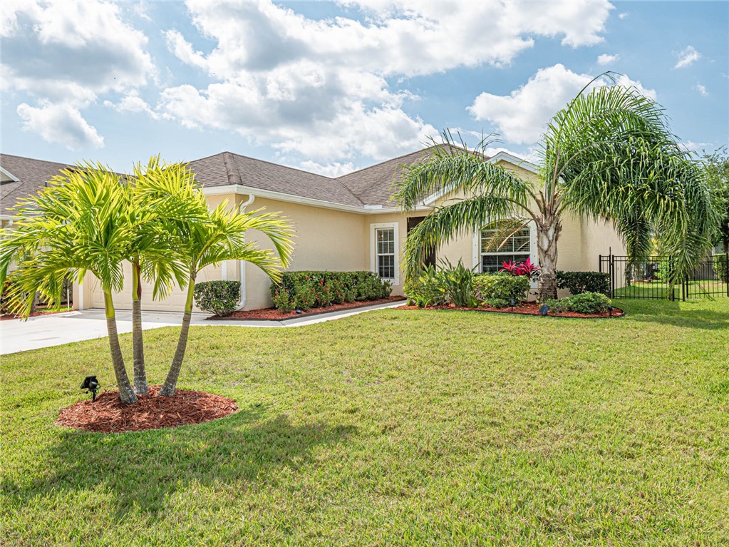 a front view of house with yard and green space