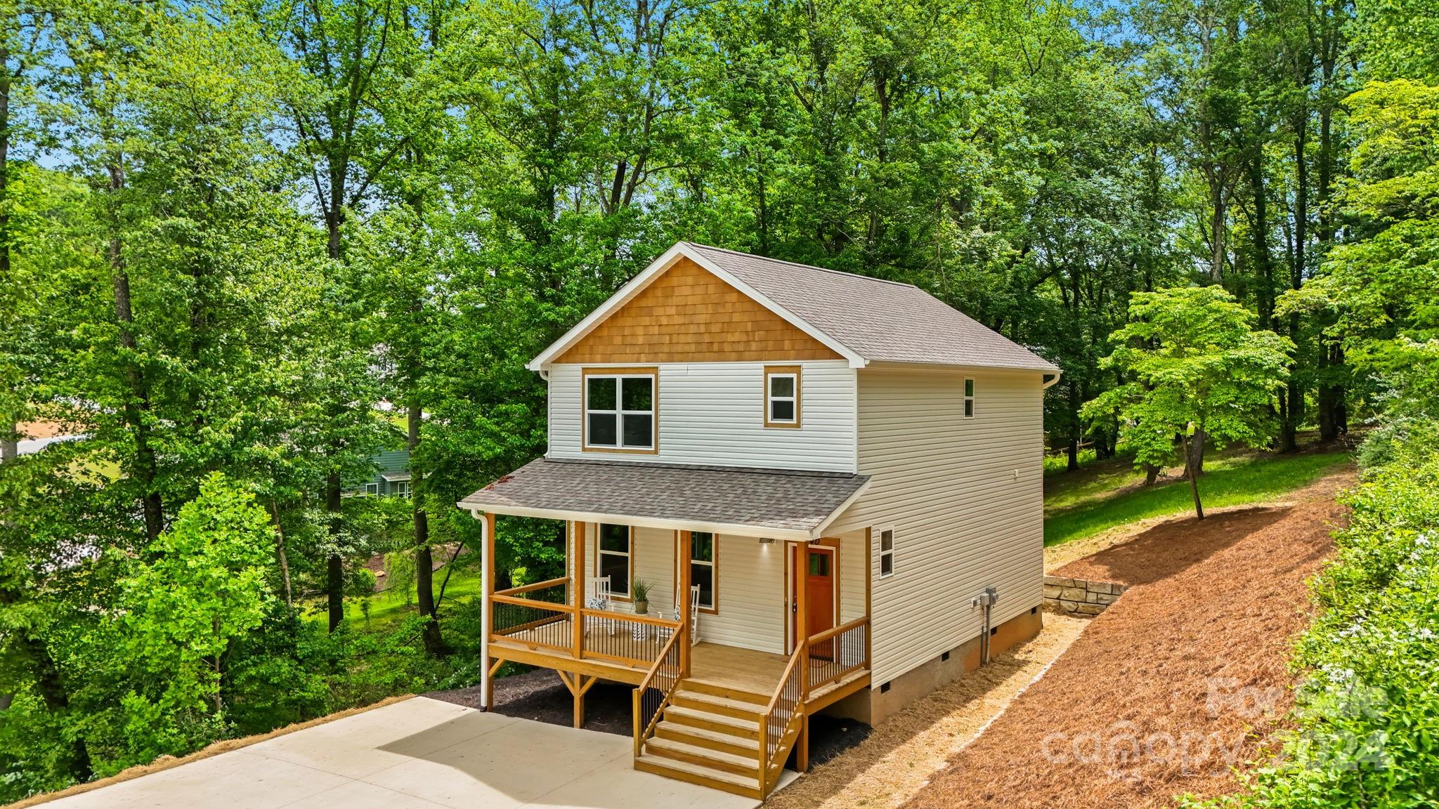 a aerial view of a house with a yard table and chairs