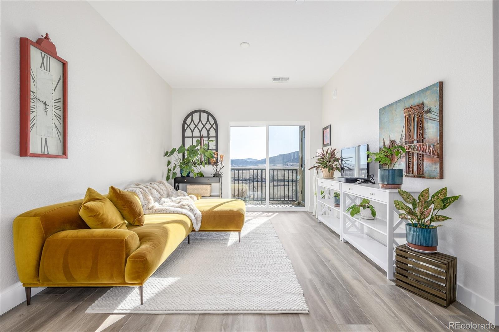 a living room with furniture and a potted plant