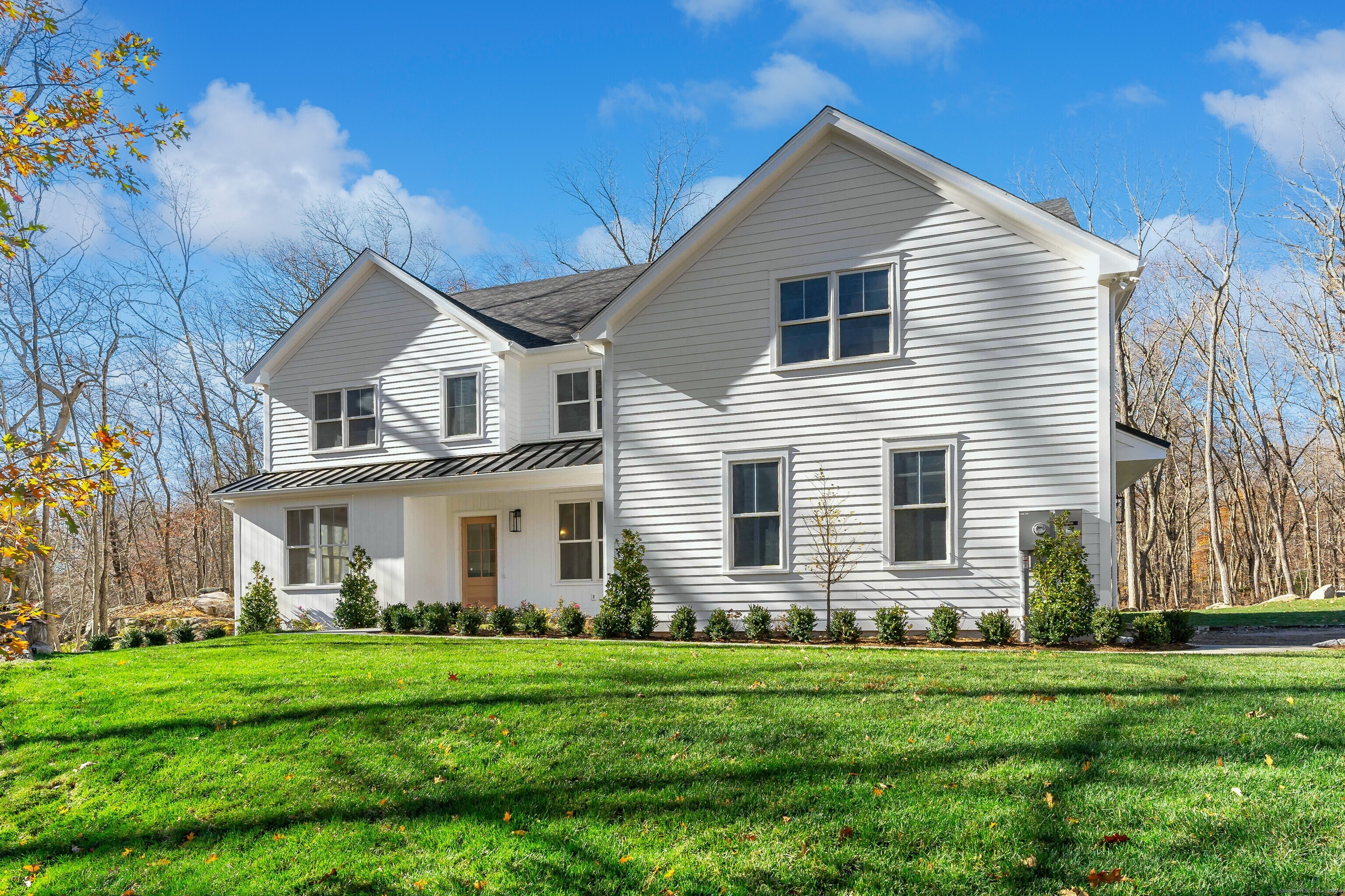 a front view of house with yard and green space