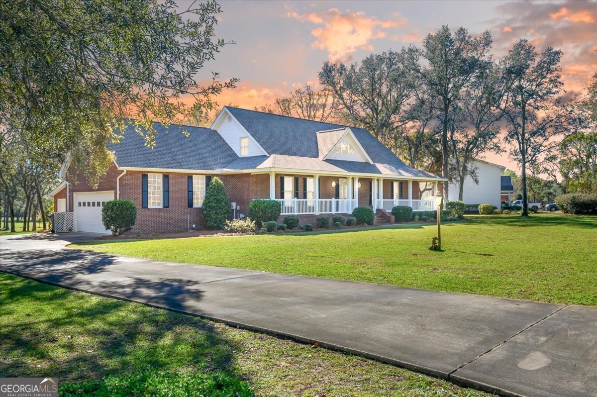 a view of an house with a backyard and a tree