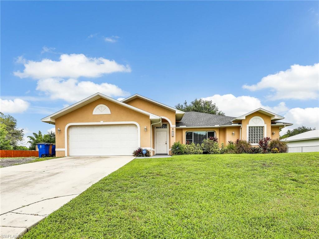 a front view of a house with a yard and garage