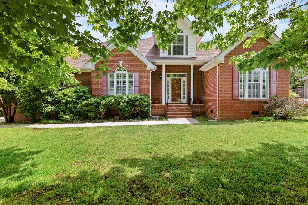 a front view of a house with garden