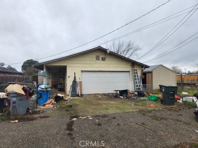 a view of a house with a yard and sitting area