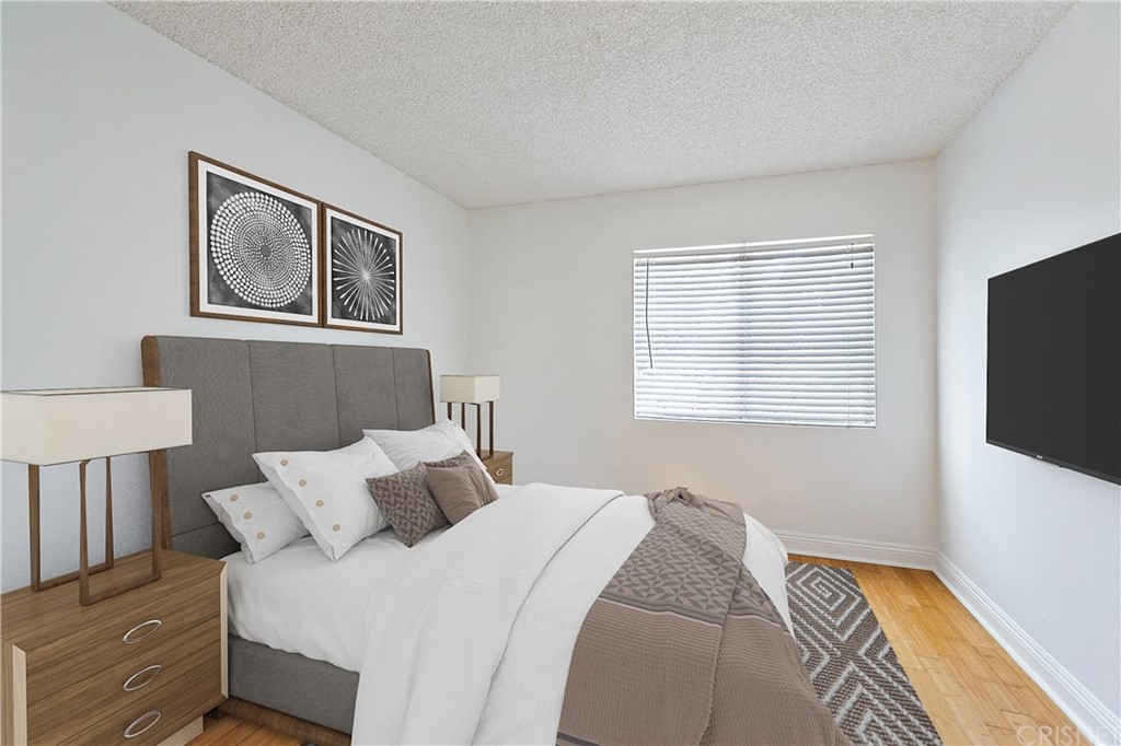 a bedroom with a bed and a flat screen tv