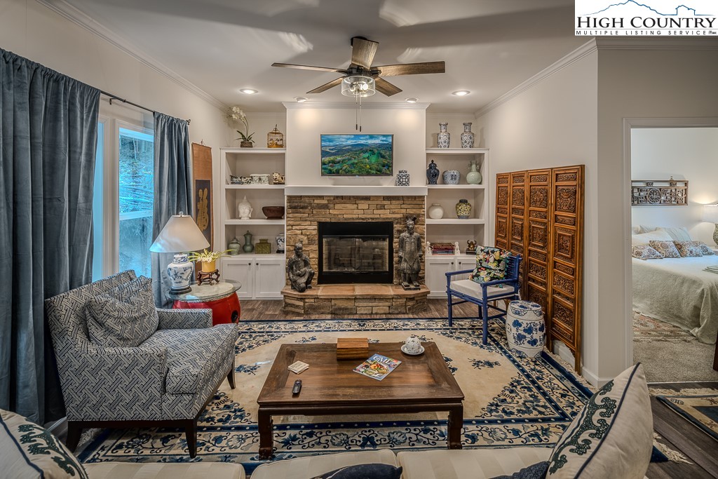 a living room with furniture a fireplace with wooden floor