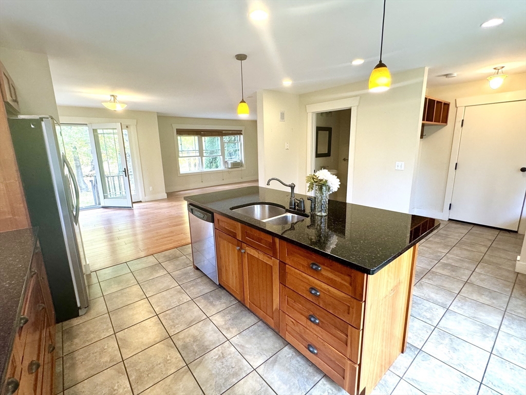 a kitchen with granite countertop a sink and a counter top space