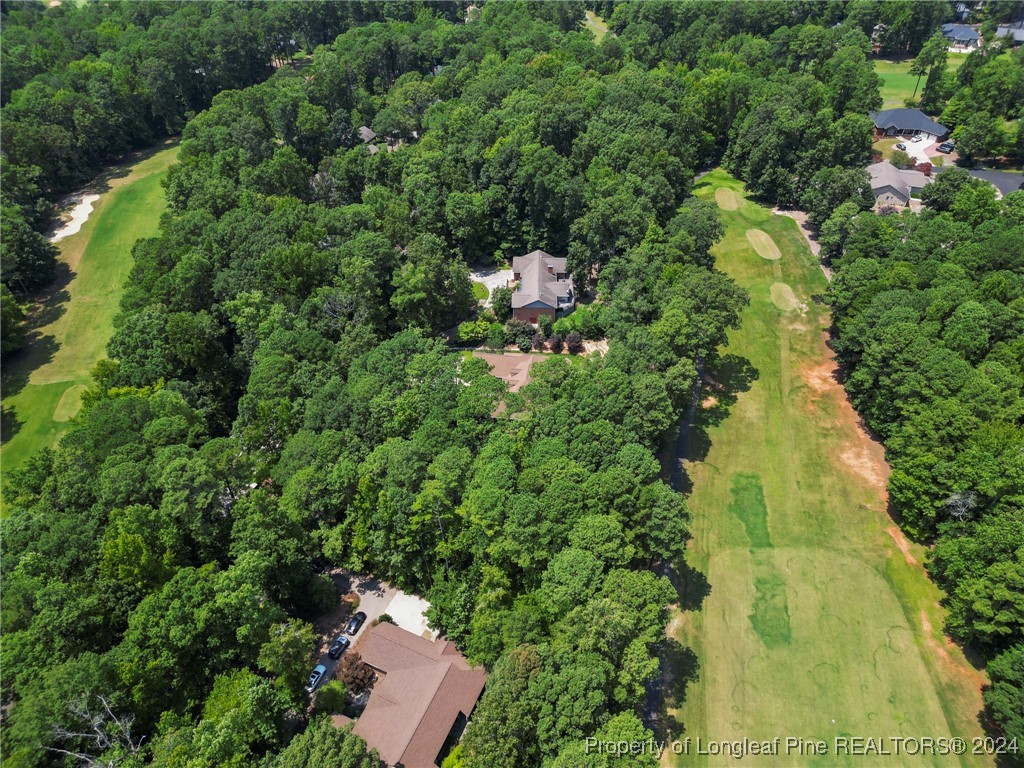 an aerial view of residential house with outdoor space and trees all around