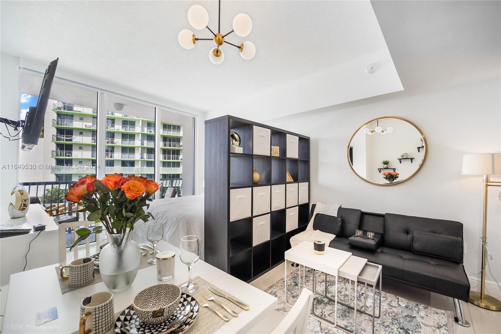 a living room with furniture a chandelier and a table