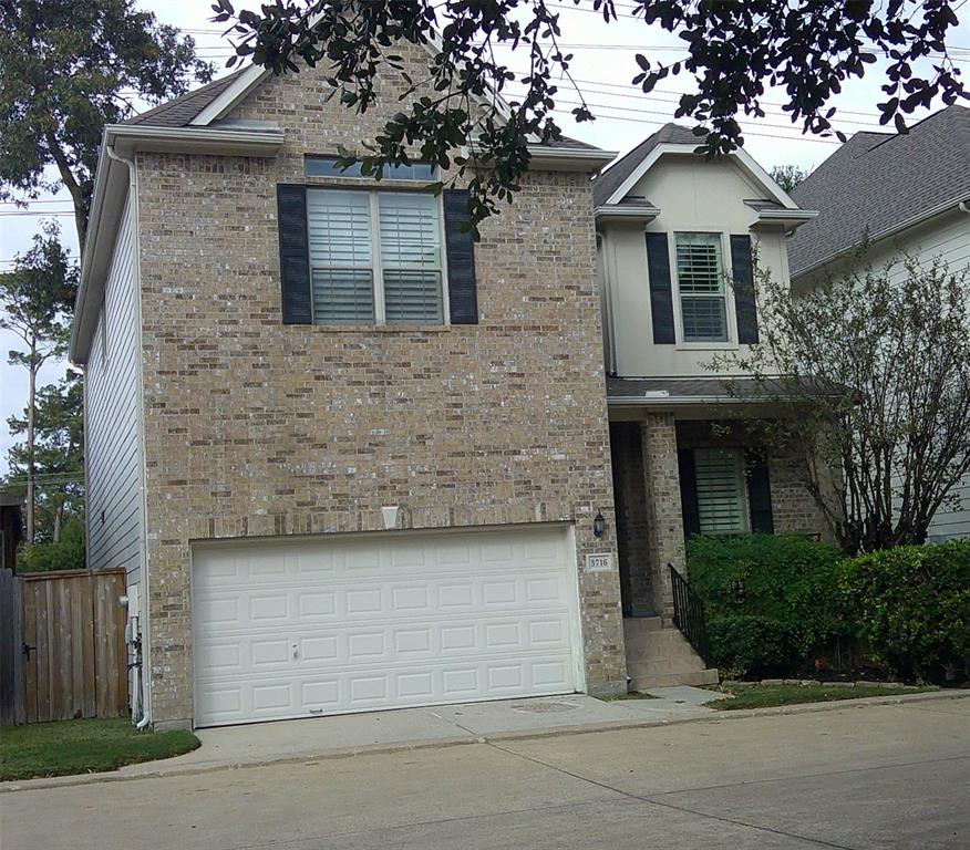 a front view of a house with garage