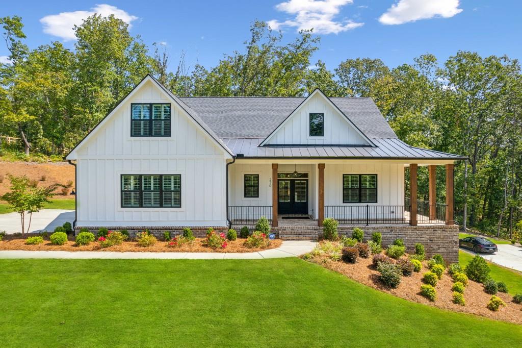 a front view of house with yard outdoor seating and green space