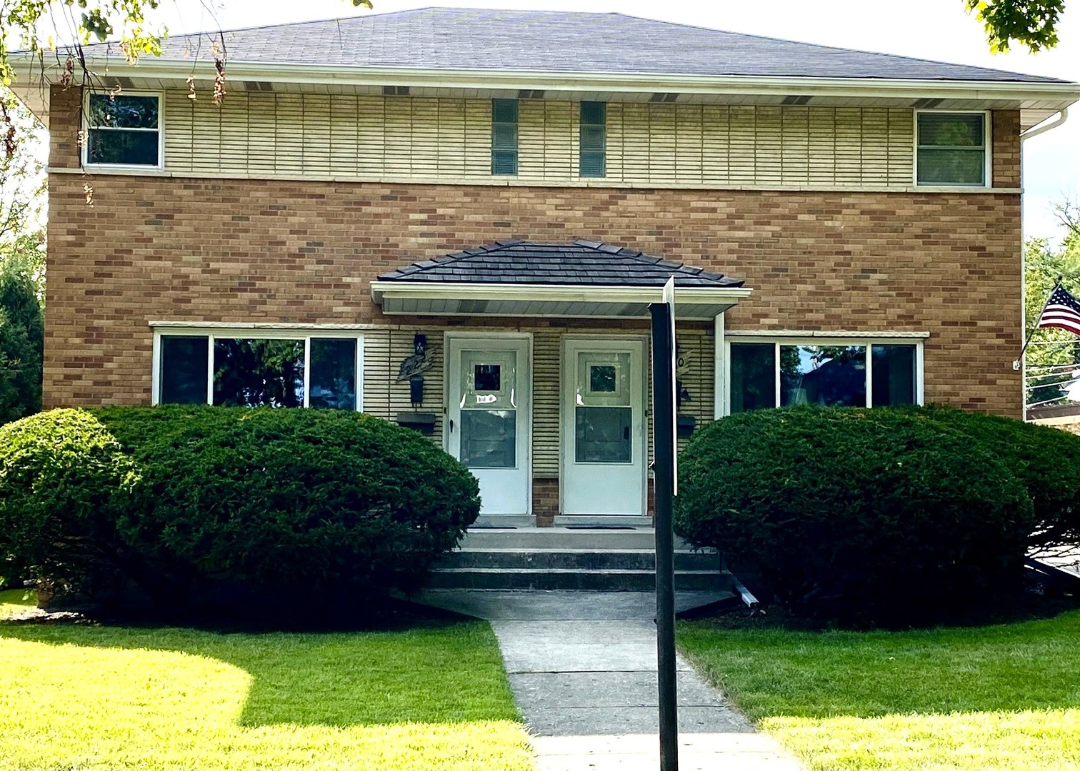 a front view of a house with a garden