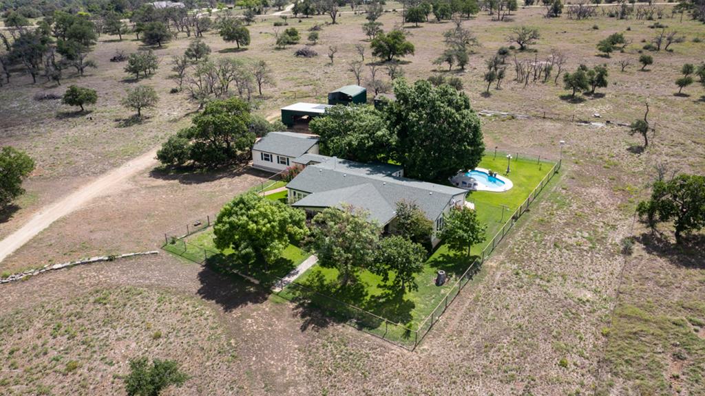 an aerial view of a house with a yard and lake view