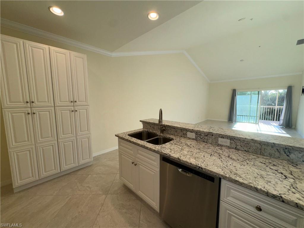 a kitchen with granite countertop a sink and a window