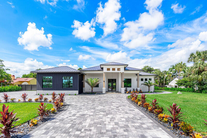 a front view of a house with a garden