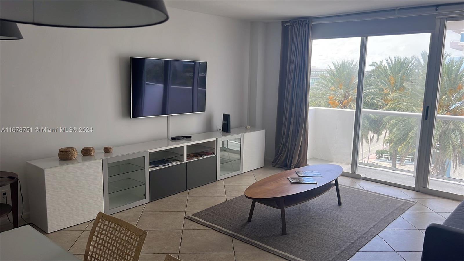 a living room with furniture a rug and a large window