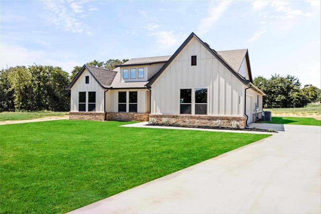 a front view of house with yard and green space