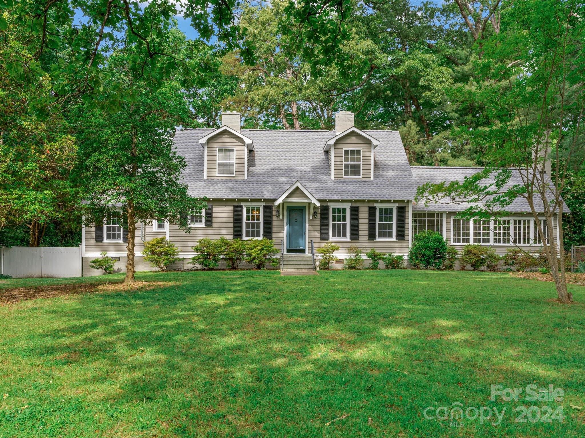 a front view of a house with a garden and porch