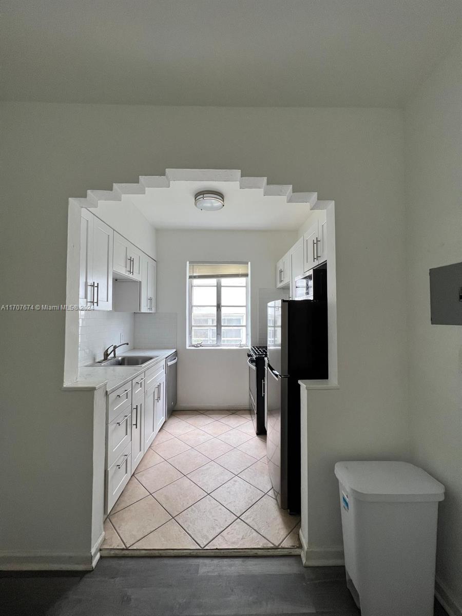 a kitchen with stainless steel appliances a stove a sink and a refrigerator