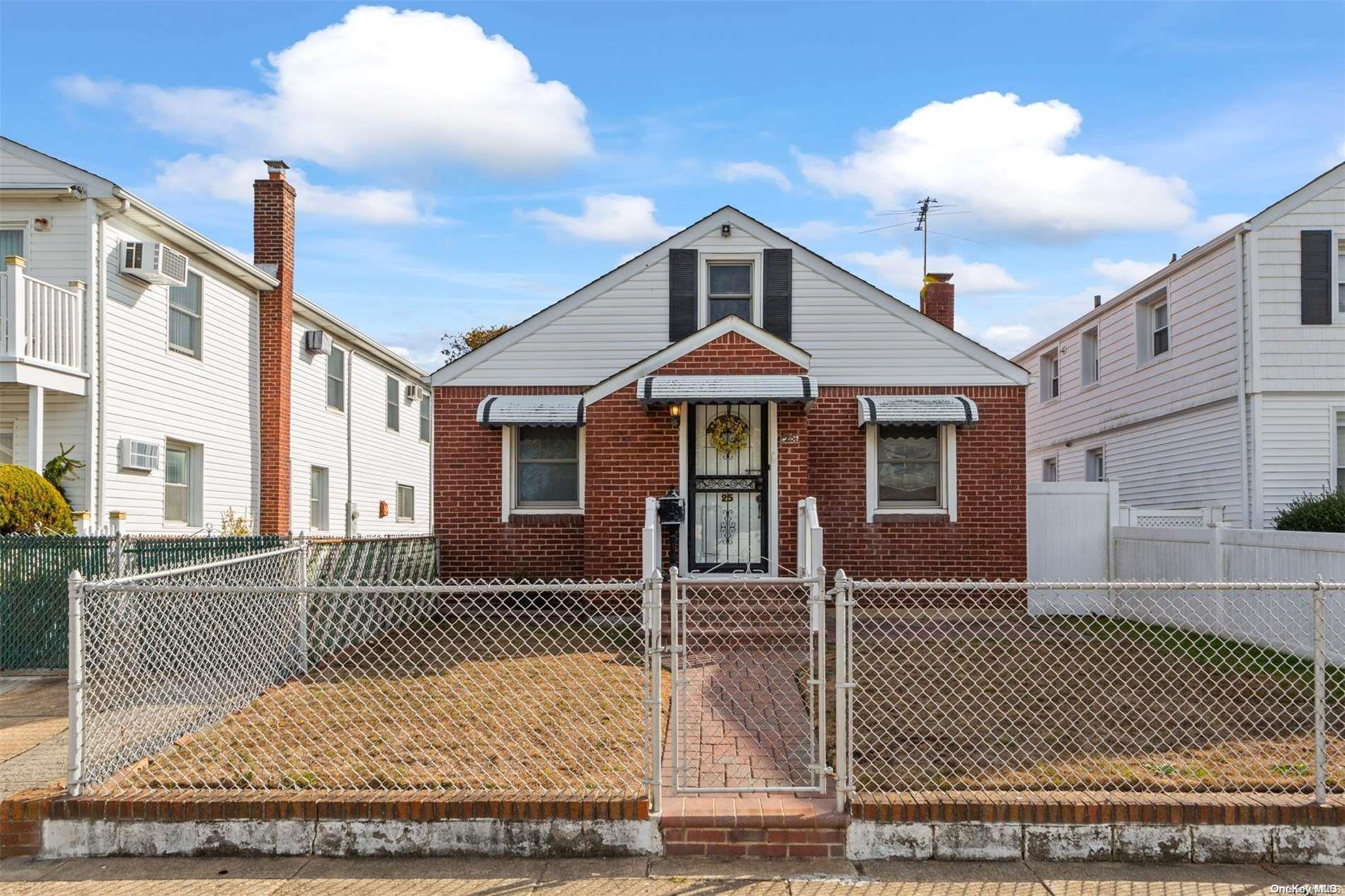 a front view of a house with a iron fence