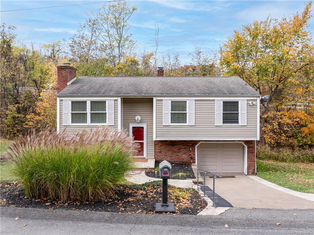 a front view of house with yard outdoor seating and green space