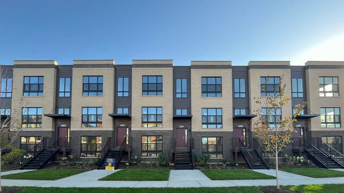 a front view of a residential apartment building with a yard