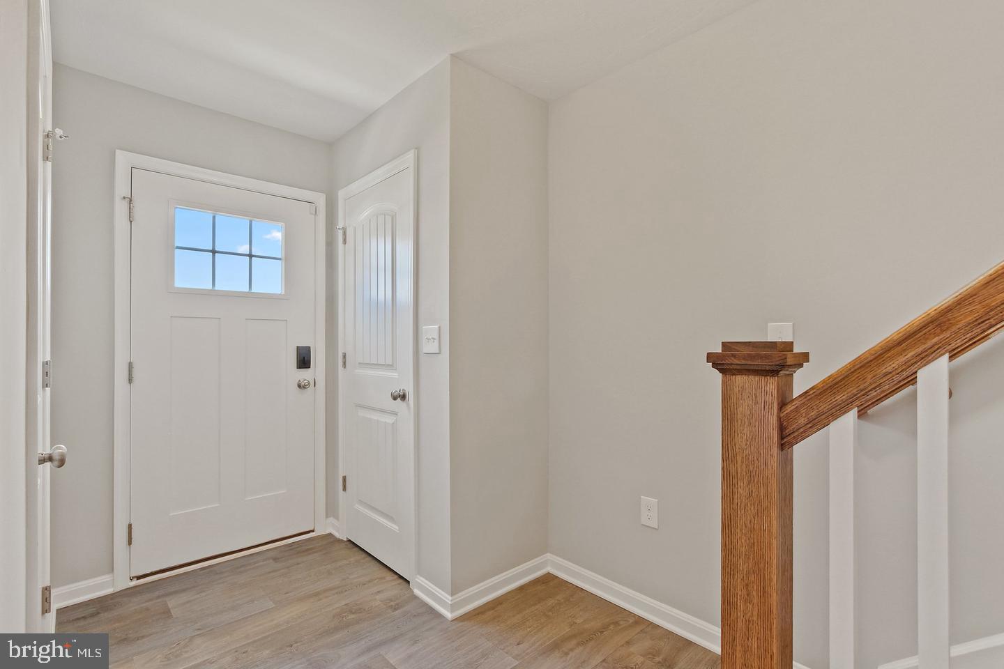 a view of an entryway with wooden floor