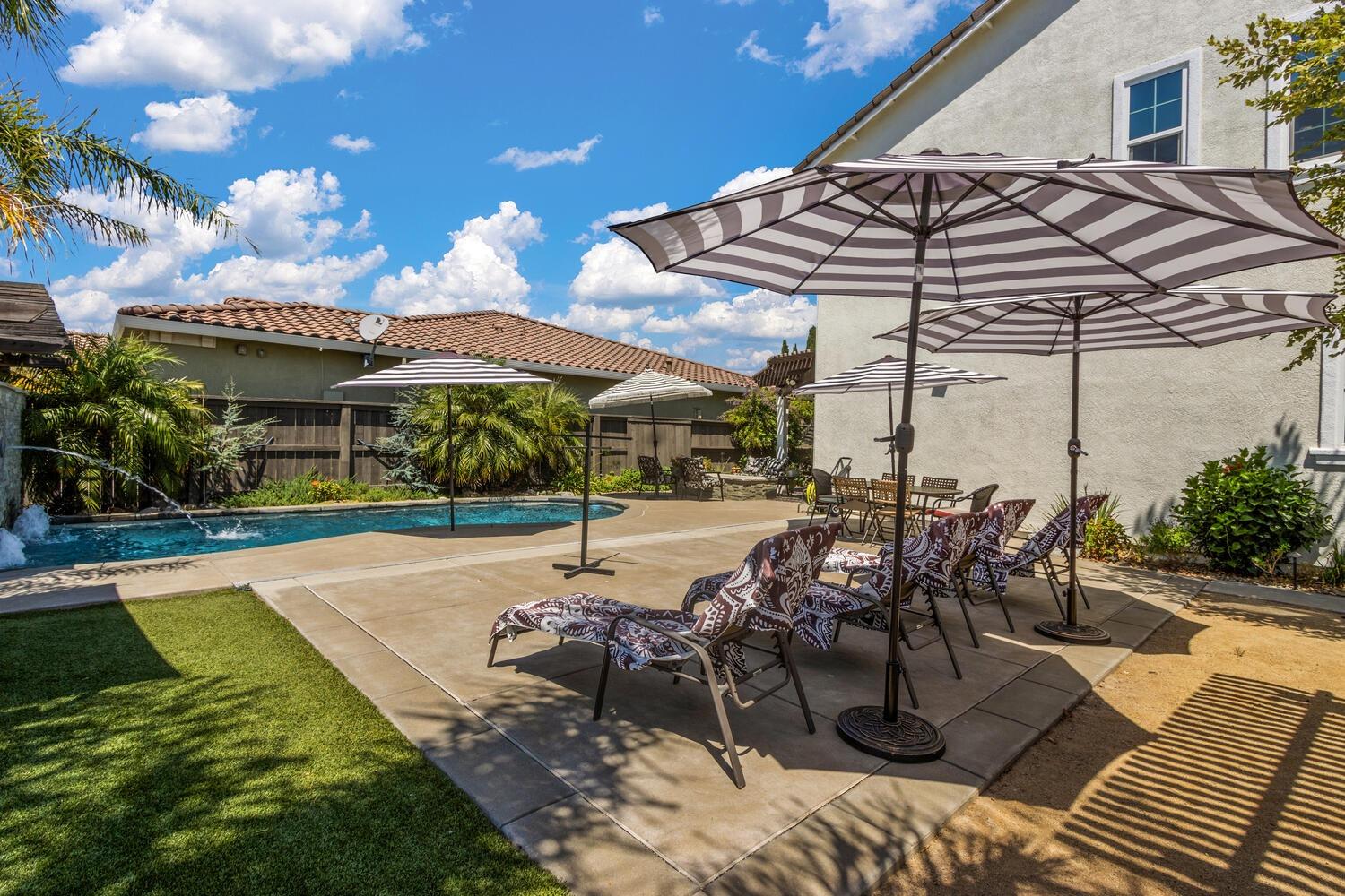 a view of a patio with a table and chairs under an umbrella