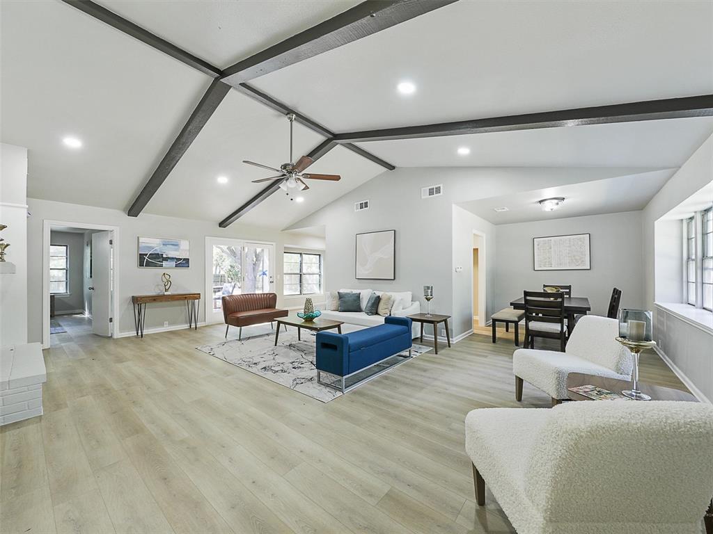 a living room with furniture and kitchen view