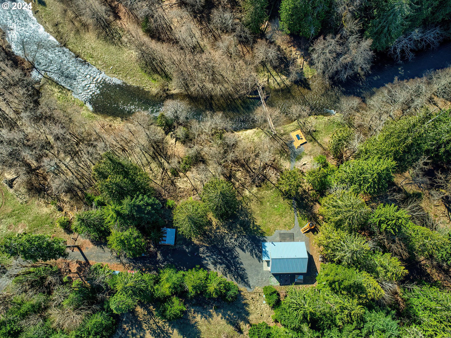 an aerial view of a house with a yard