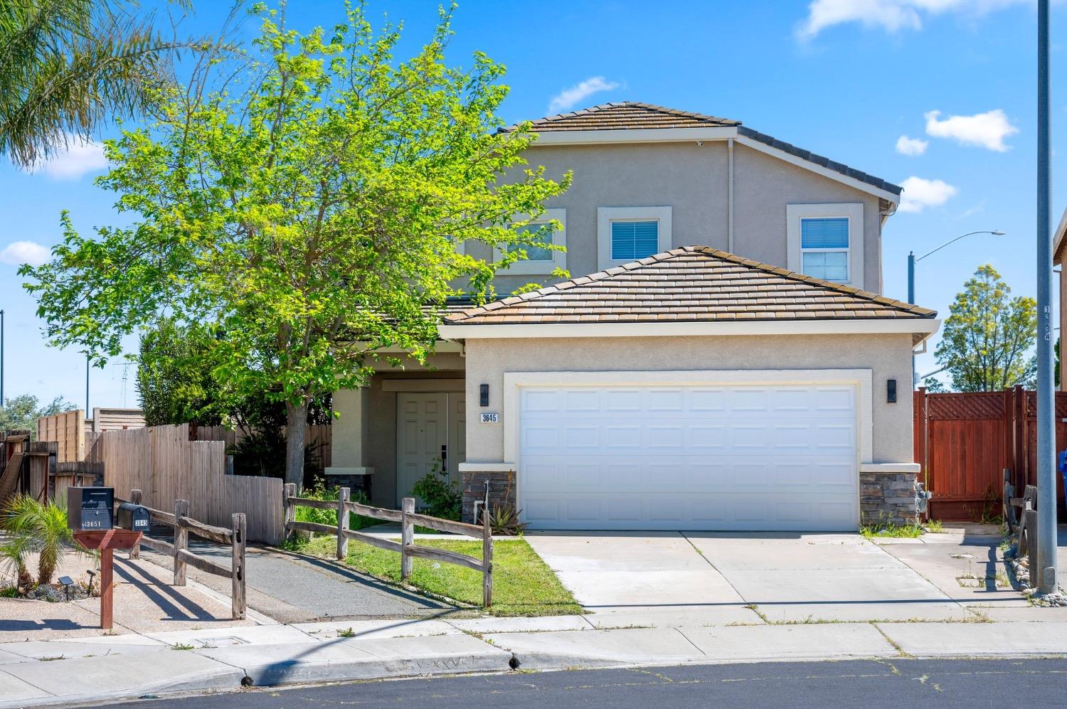 a front view of a house with garage