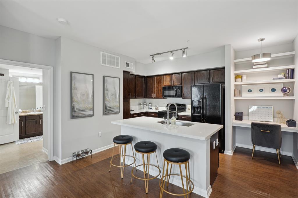 a kitchen with stainless steel appliances kitchen island granite countertop a sink and cabinets