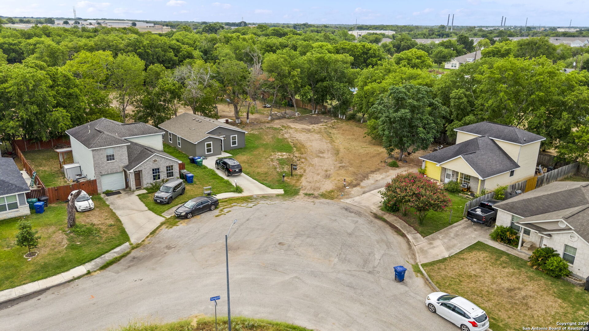 an aerial view of a house with garden space and street view