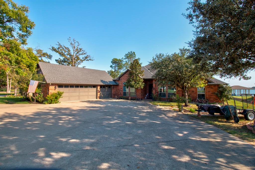 a front view of a house with a yard and a garage