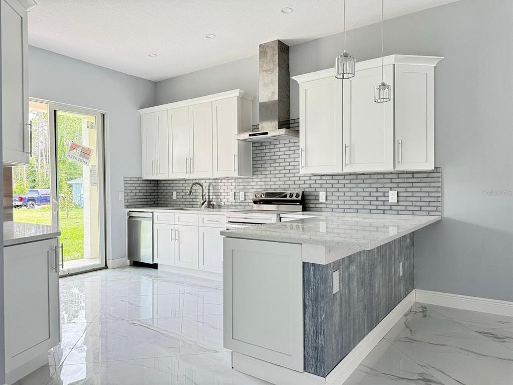 a kitchen with a sink stove and cabinets