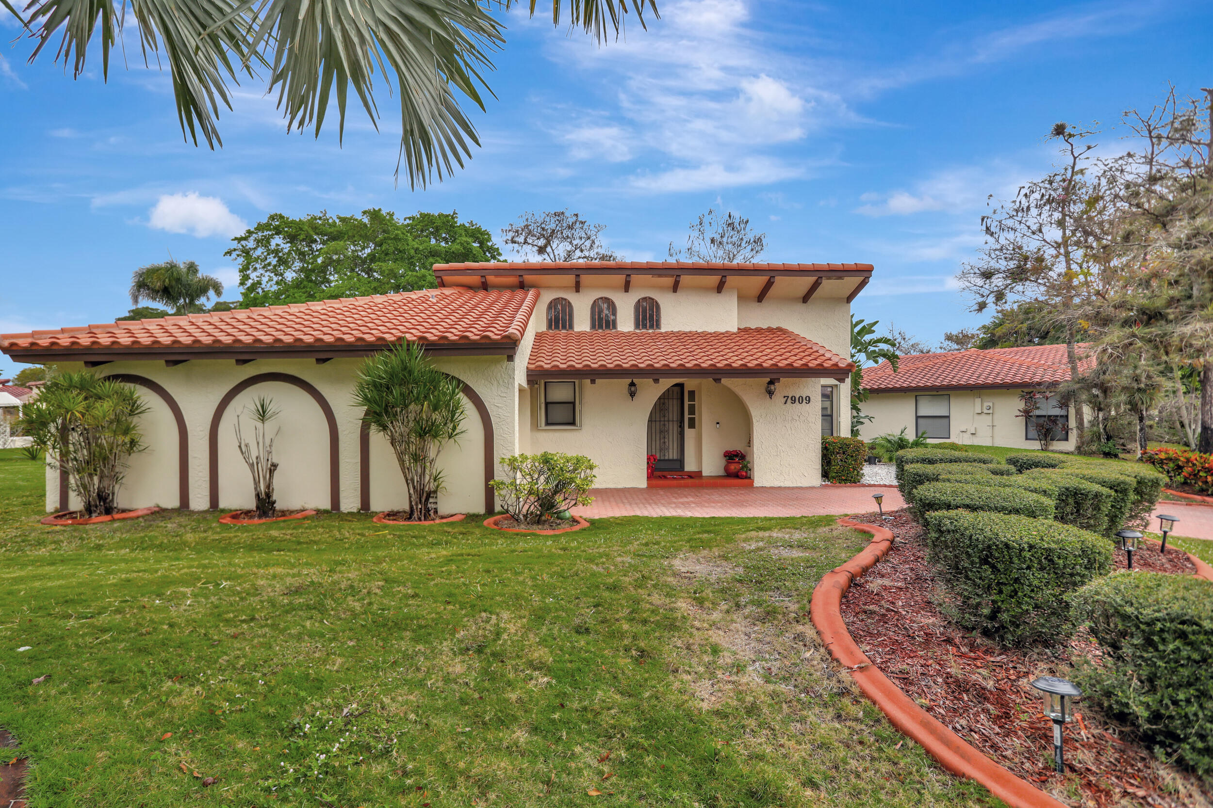 a front view of house with yard and outdoor seating