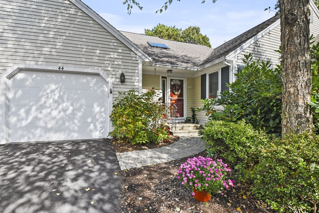 a front view of a house with a yard and fountain